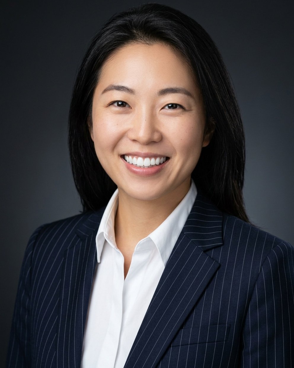 Charcoal studio headshot, pinstripe suit